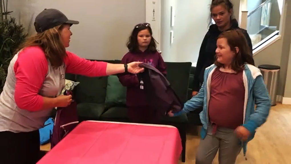 Owen Hart Foundation gives away hundreds of backpacks to children in need